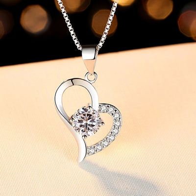 Fall in love with our 925 sterling silver necklace plated with white gold, featuring a 1 CT round shape lab-created moissanite diamond heart pendant. Perfect for gifting or adding some sparkle to your own collection!